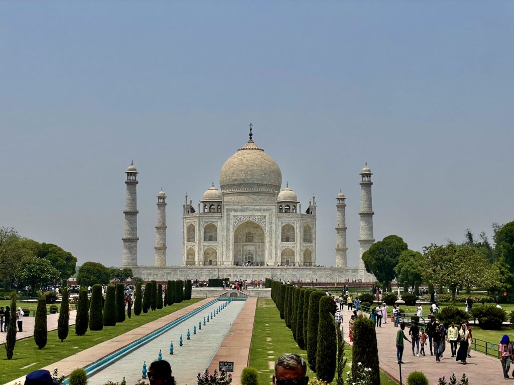 The iconic Taj Mahal in Agra, India, with its majestic white marble structure and reflecting pool, symbolizing eternal love and architectural brilliance.