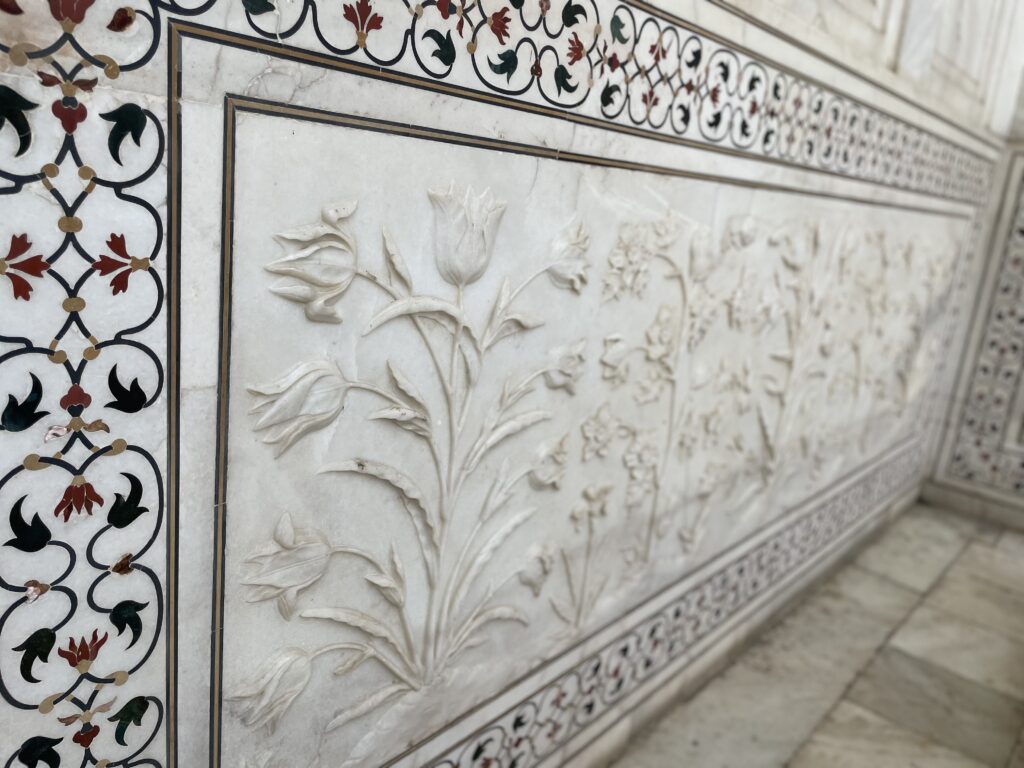 Close-up of the intricate white marble details on the Taj Mahal, showcasing the exquisite craftsmanship and delicate carvings of this UNESCO World Heritage Site.