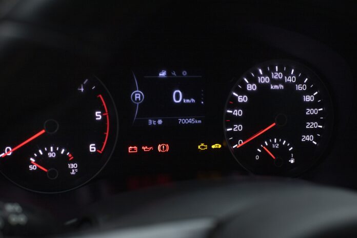 A person checking engine oil and inspecting a car’s tire pressure for proper vehicle maintenance.